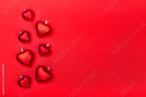 Valentines Day greeting card with red hearts on red background. Top view with empty space for your text. Flat lay, copy space