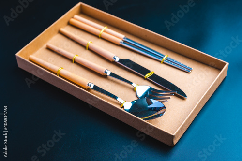  Kitchen tools set with knife, fork, and spoon on dark background