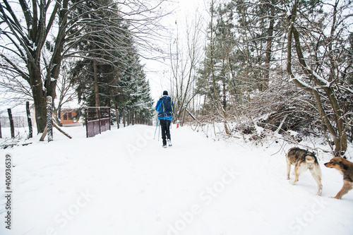 Active lifestyle, rear view of hiker walk on snowy day at winter season.