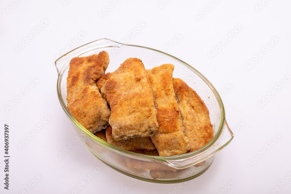 Breaded fish fillets in a glass, heat-resistant dish