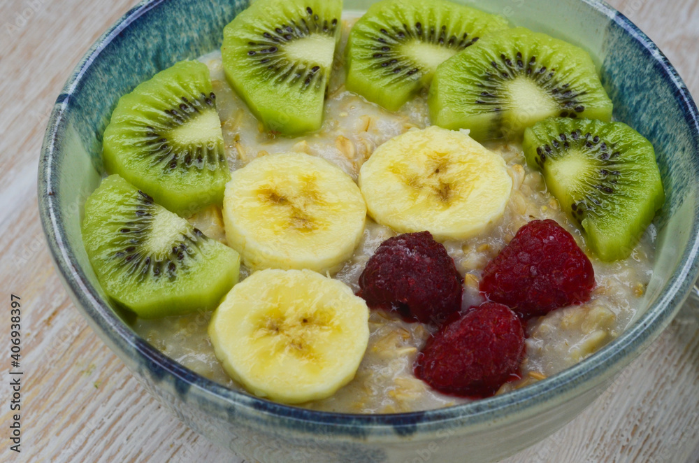 Healthy food for breakfast top view flat lay. Oatmeal porridge with berry, kiwi and banana fruit Healthy food for breakfast top view flat lay. Oatmeal porridge with berry, kiwi and banana fruit