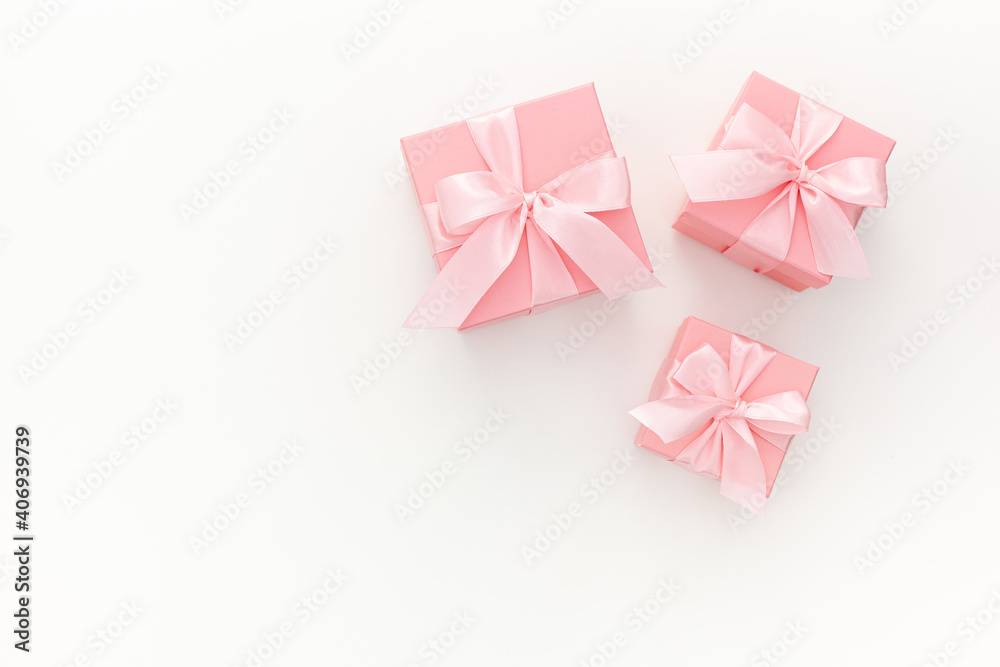 Valentines day composition: three pink gift boxes with ribbon