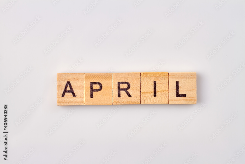 April word written on wood blocks. Isolated on white background. April word written on wood blocks. Isolated on white background.