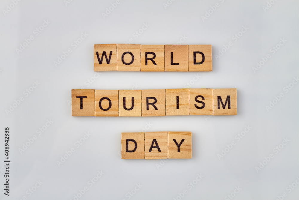 World tourism day concept. Alphabet wooden blocks with letters on white background. World tourism day concept. Alphabet wooden blocks with letters on white background.