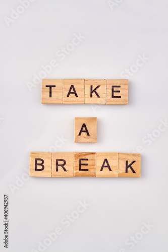 Concept of the rest and relaxation. Take a break made with wooden building blocks isoleted on white background.