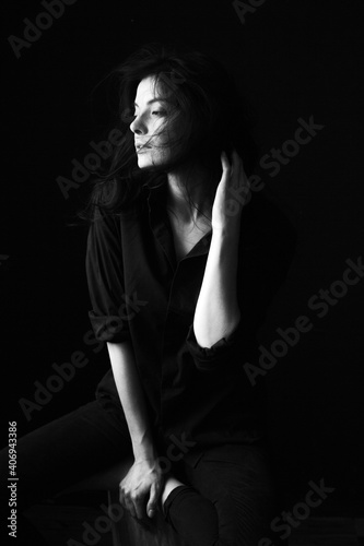 Emotional Sensual black and white portrait of a beautiful girl on a dark background