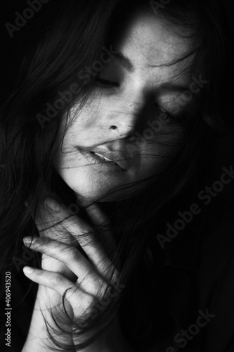 Fototapeta Naklejka Na Ścianę i Meble -  Emotional Sensual black and white portrait of a beautiful girl on a dark background