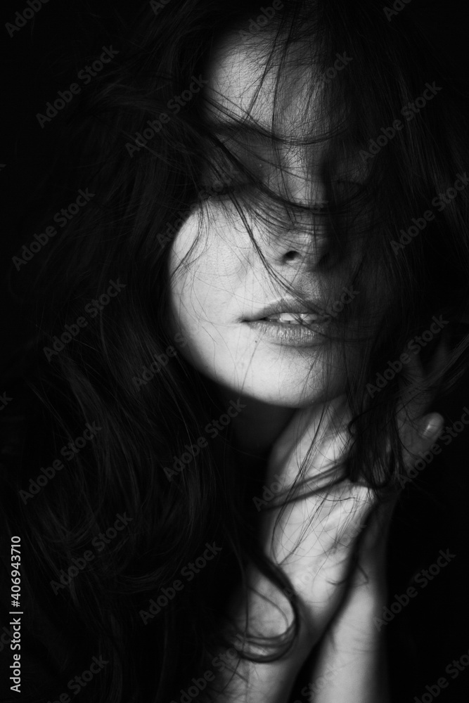 Emotional Sensual black and white portrait of a beautiful girl on a dark background