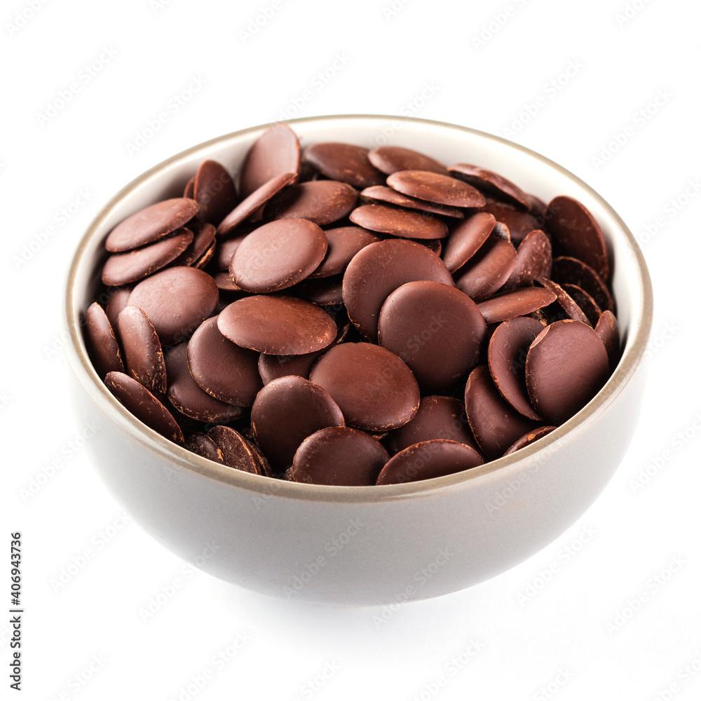 Chocolate chips or granules for making melted chocolate. Confectionery chocolate in a bowl on white background.