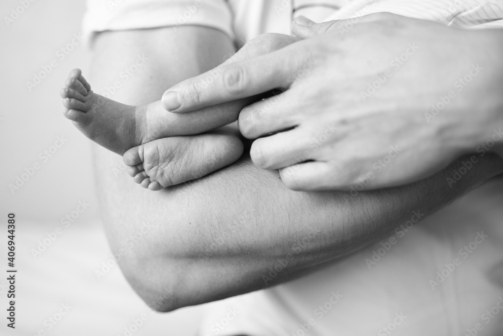 Father holds on arm of the newborn child. High quality photo Father holds on arm of the newborn child. High quality photo