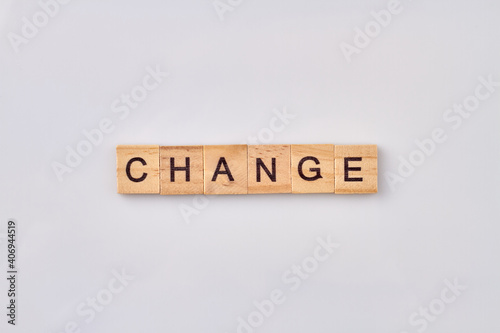 Change written with wooden blocks. Conceptual quote of improvement yourself. Isolated on white background.