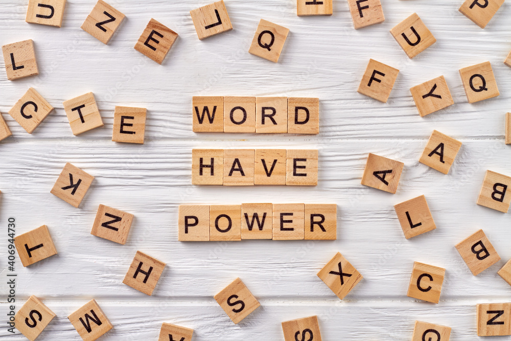 Phrase words have power on wood floor. Blocks of alphabet letters on background.