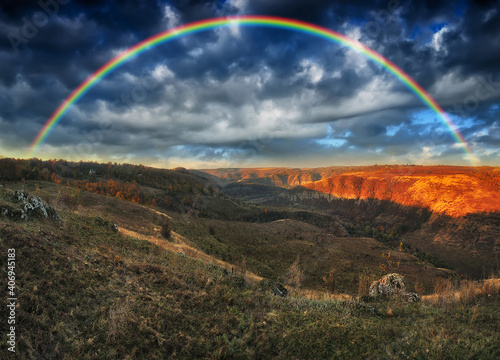 Rainbow with clouds over the canyon. autumn landscape