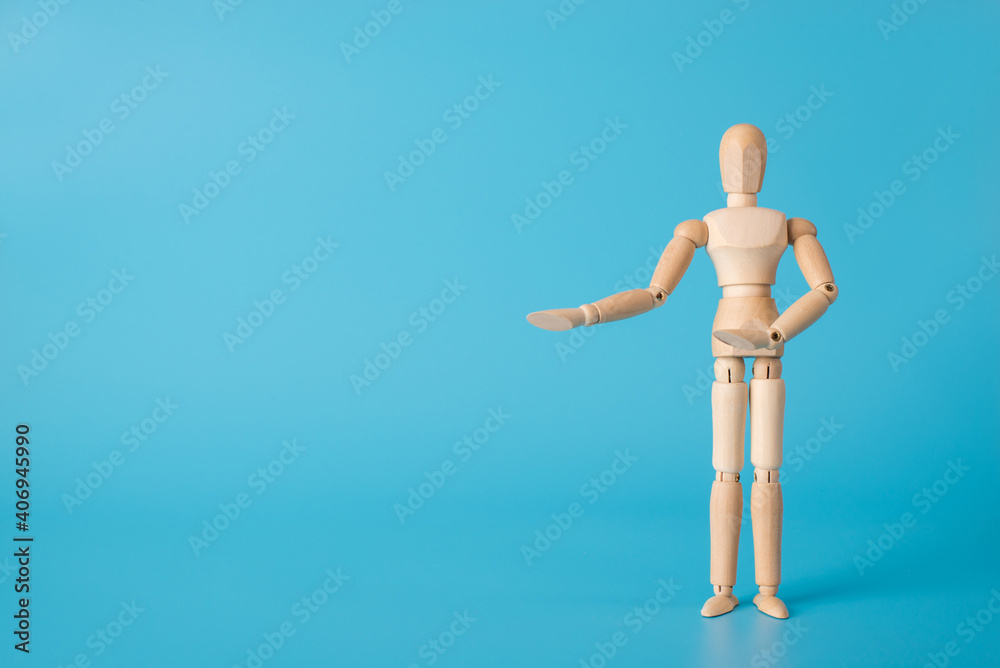 Welcome back concept. Photo of wooden male figure showing hands to the side isolated blue backdrop with copy space Welcome back concept. Photo of wooden male figure showing hands to the side isolated blue backdrop with copy space