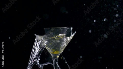 Slow Motion Close Up Of A Martini Glass ExplodIng As An Olive Drops Onto The Lip Of The Glass