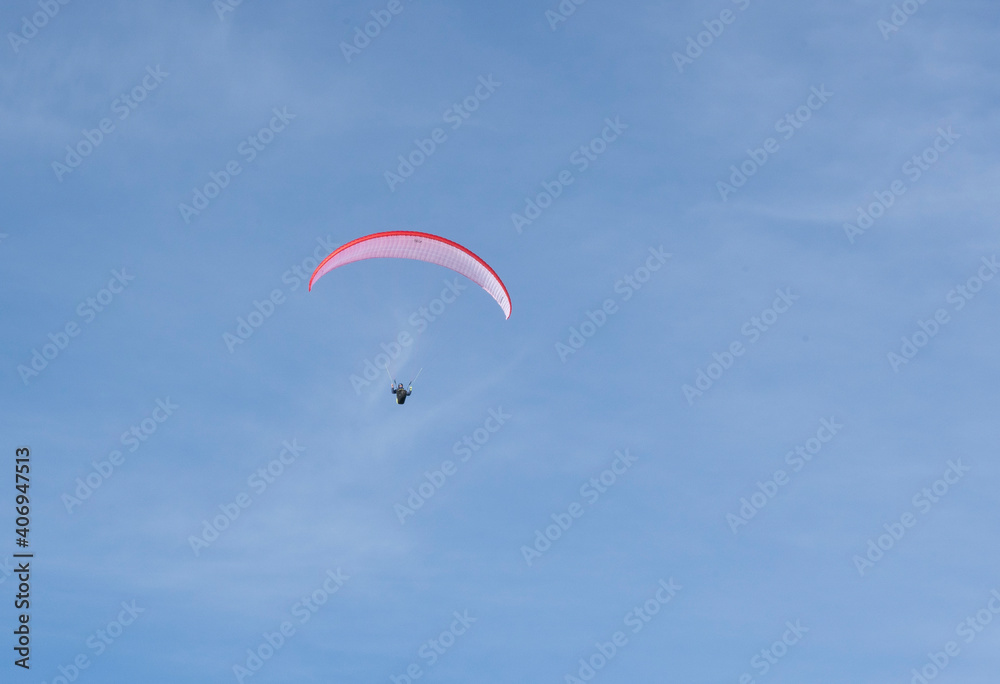 Paraglider flying over the mountains in winter Paraglider flying over the mountains in winter