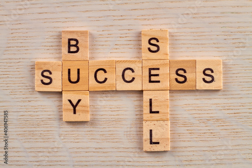 Basic economy terms. Buy and sell for success in business. Top view of wooden blocks on the desk.