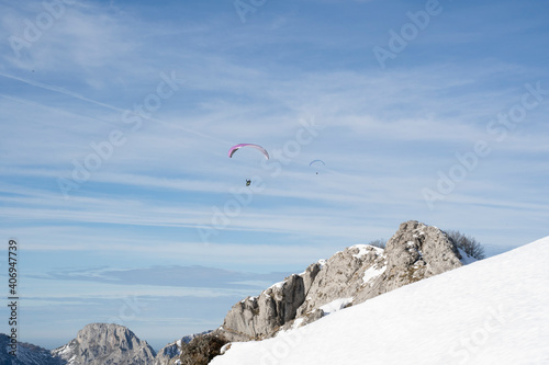 paragliders flying over the mountains 