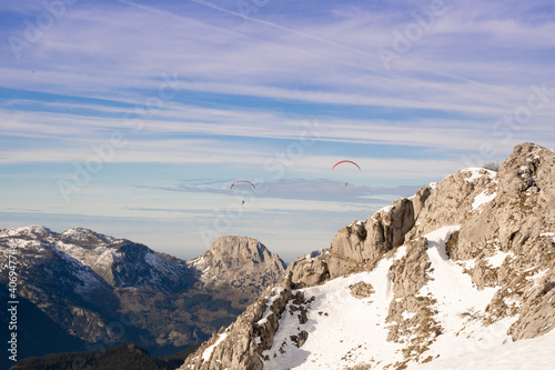 paragliders flying over the mountains 