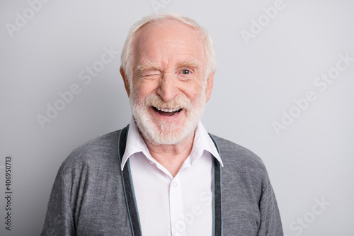 Portrait of old white hair optimistic man blink wear dark sweater isolated on grey background