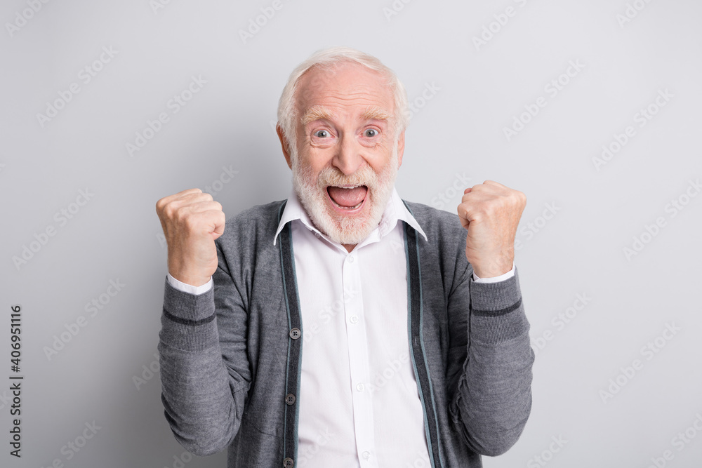 Portrait of old white hair hooray funny man hands fists wear dark sweater isolated on grey background Portrait of old white hair hooray funny man hands fists wear dark sweater isolated on grey background