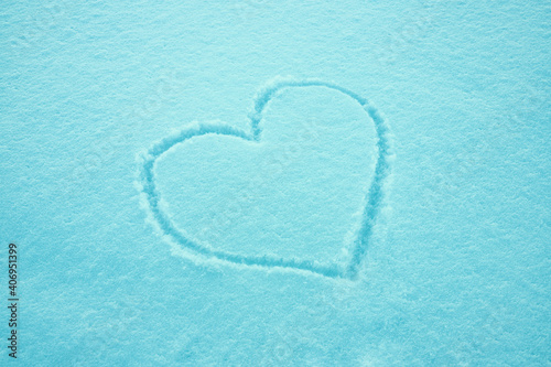 Drawing of heart in the snow. Valentine's day concept. Love symbol. Texture. Postcard, place for text.