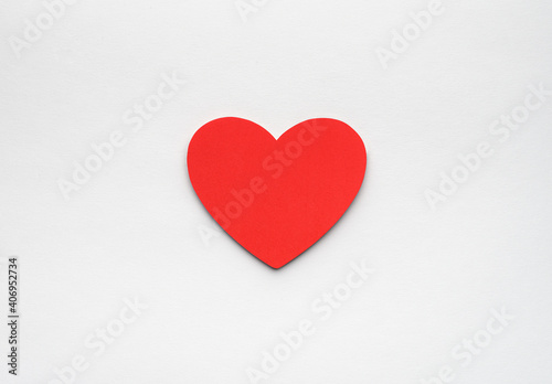 Red paper heart on white background