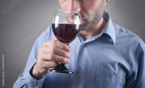 Young caucasian man with a glass of red wine.