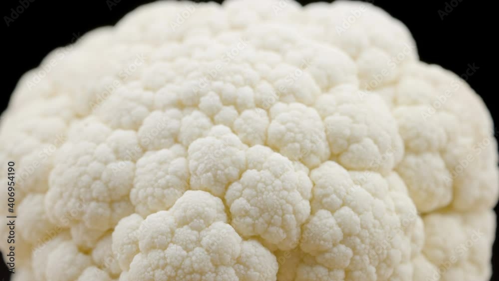 The head part of the white cauliflower vegetable on top of the wooden board in Estonia The head part of the white cauliflower vegetable on top of the wooden board in Estonia