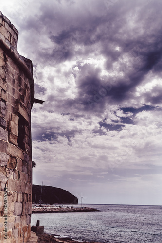 Beautiful view of the sea from a medieval castle with a mountain on a stormy day