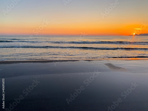 Beautiful orange sunset at the sand beach