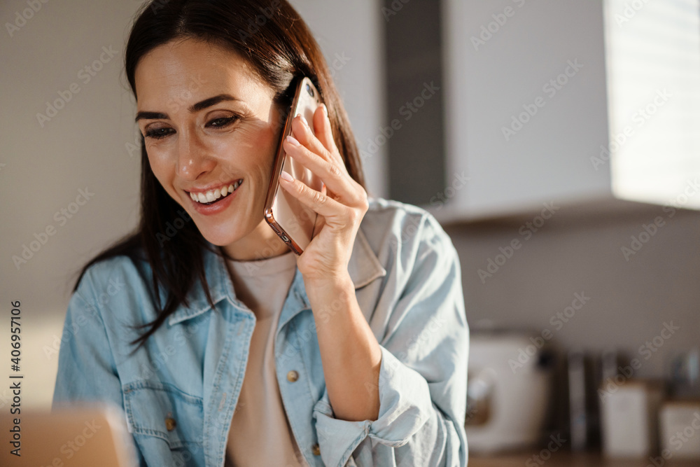 Beautiful woman using mobile phone and laptop computer Beautiful woman using mobile phone and laptop computer