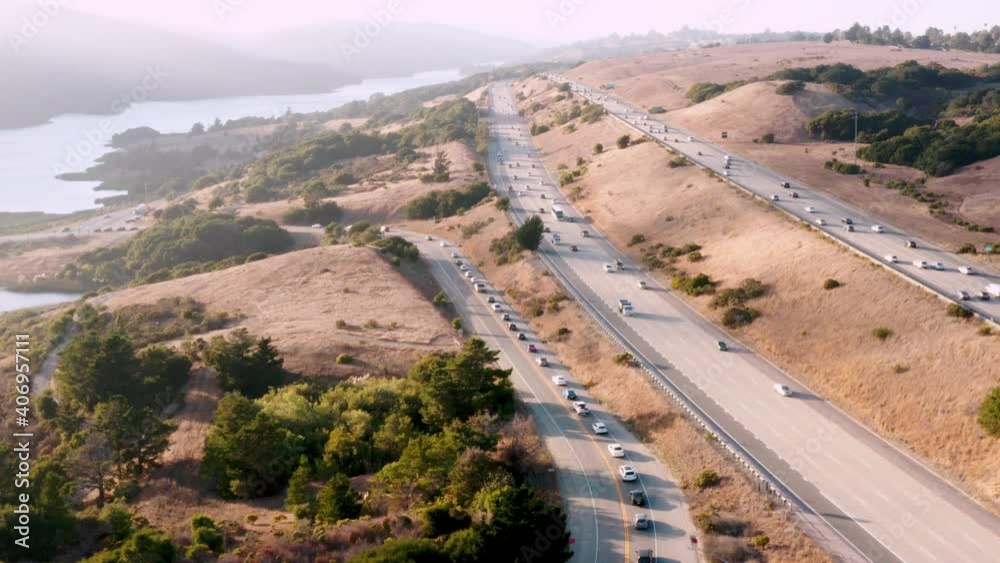Aerial: Cars on the freeway, mountains, and trees, drone view 04