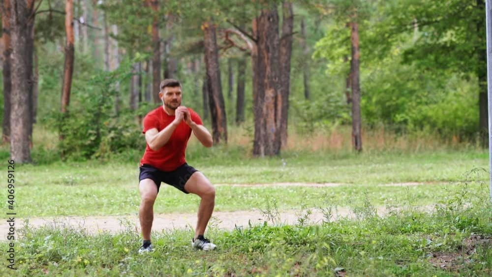 Man doing squats at the edge of the park. Man doing squats at the edge of the park.
