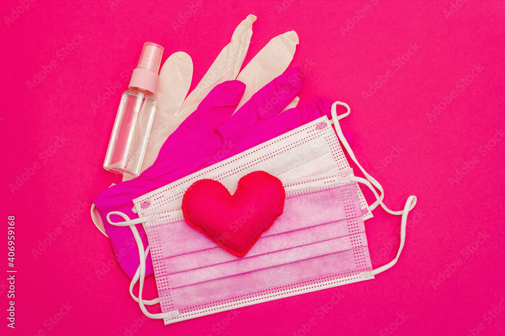 Red heart with medical protection mask on bright pink background Red heart with medical protection mask on bright pink background