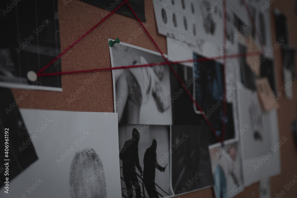 Detective board with crime scene photos, stickers, clues and red thread ...