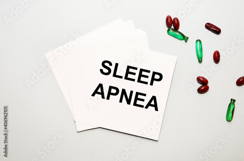 On the sheets for notes the text SLEEP APNEA, next to red and green capsules.