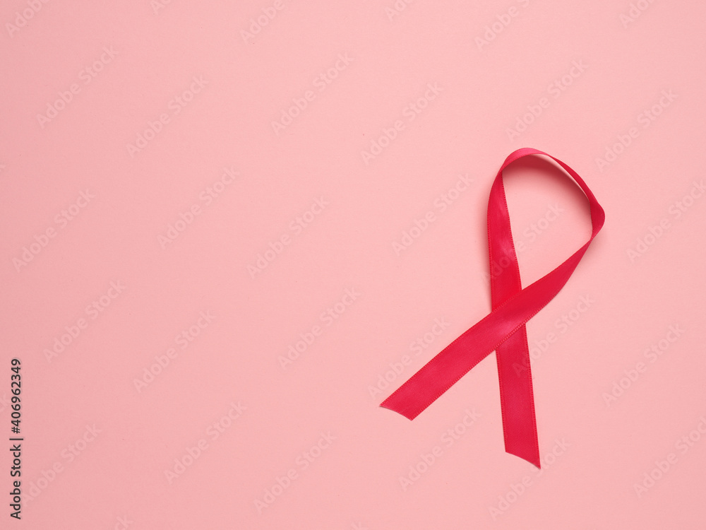 Pink ribbon curl on a pink paper background ,symbol for Liver Cancer awareness, World Cancer Day Pink ribbon curl on a pink paper background ,symbol for Liver Cancer awareness, World Cancer Day