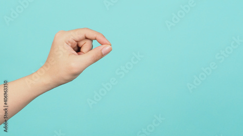 Empty Hand holding or catch nothing guesture on green and blue or mint background.