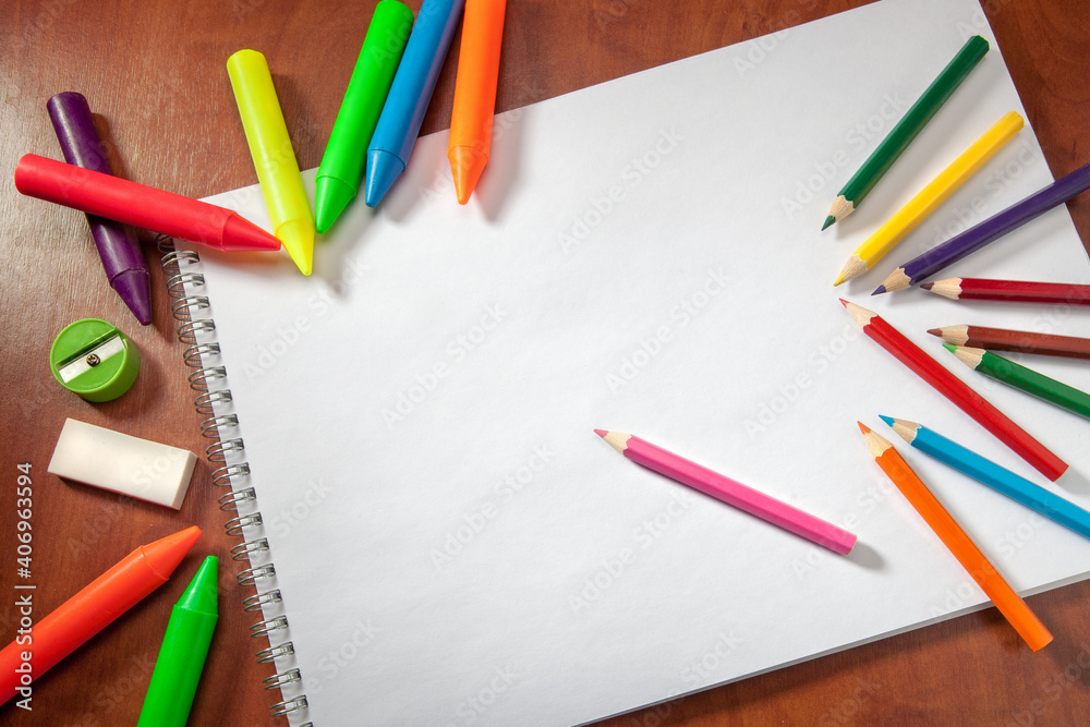Colored pencils and a drawing pad. The concept of school children's creativity Colored pencils and a drawing pad. The concept of school children's creativity