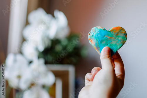 Multicolored hearts made of plasticine by a child.
