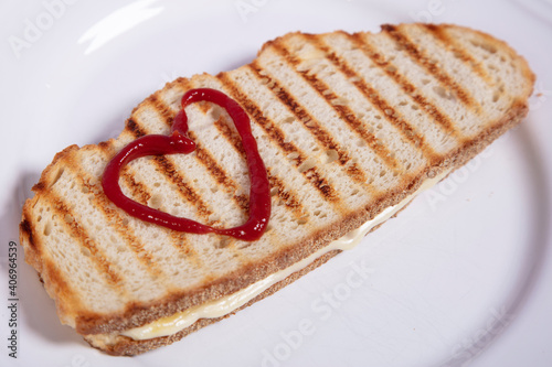 sandwich with drawn ketchup  hearts, close up top view