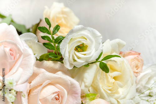 flower composition of light roses and eustoma close up. wedding day greeting card.