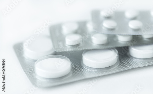 White pills on white background, medicine background