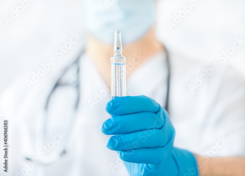 Ampoule with medicine in doctor's hand