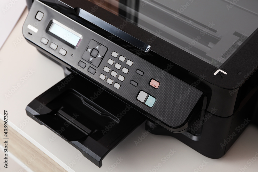 Closeup view of new modern printer with control panel on white table Closeup view of new modern printer with control panel on white table