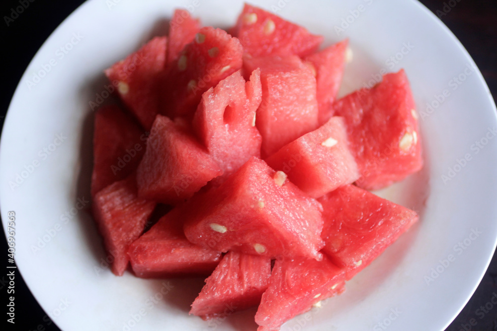 close up of sliced red watermelon in a white plate close up of sliced red watermelon in a white plate