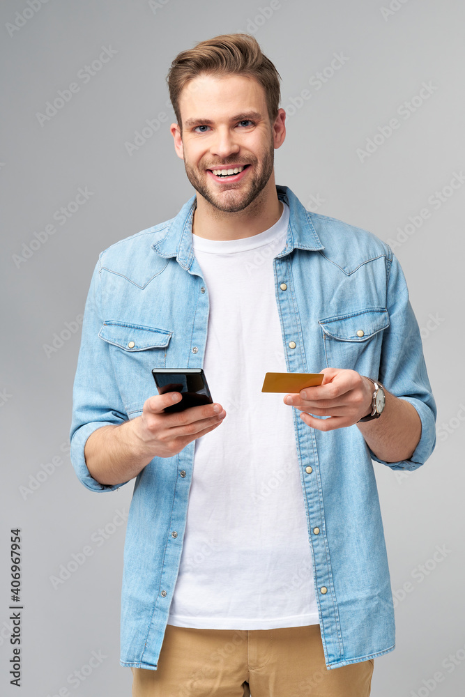 Handsome happy young man showing blank bank cor discount card Handsome happy young man showing blank bank cor discount card
