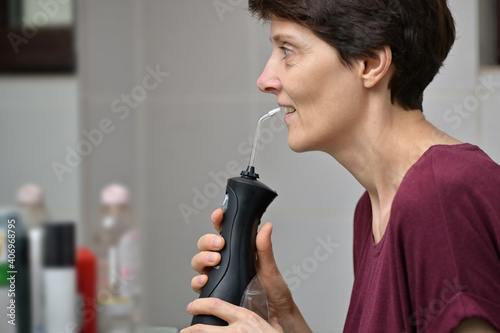 Portrait Of A Young Womanand and Professional Oral Irrigator photo