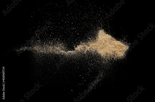 Sand flying explosion on black background ,throwing freeze stop motion object design